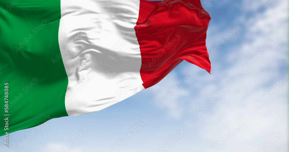 Obraz premium Italy national flag waving in the wind on a clear day