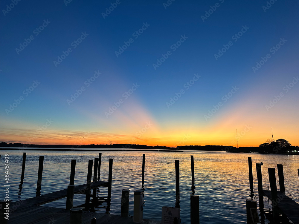 Beautiful sunset over the Chesapeake Bay near Annapolis, Maryland - the sky is illuminated in so many different colors and reflecting on the ocean water