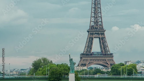 The Statue of Liberty and the Eiffel Tower Timelapse. Aerial view from Mirabeau bridge before sunset. Paris, France photo