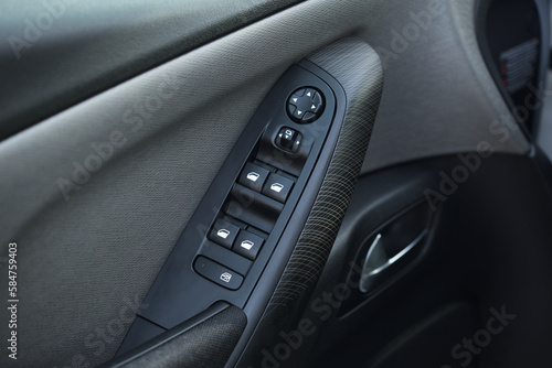 close-up of the side door buttons: window adjustment buttons, door lock. modern car interior: parts, buttons, knobs © lial88