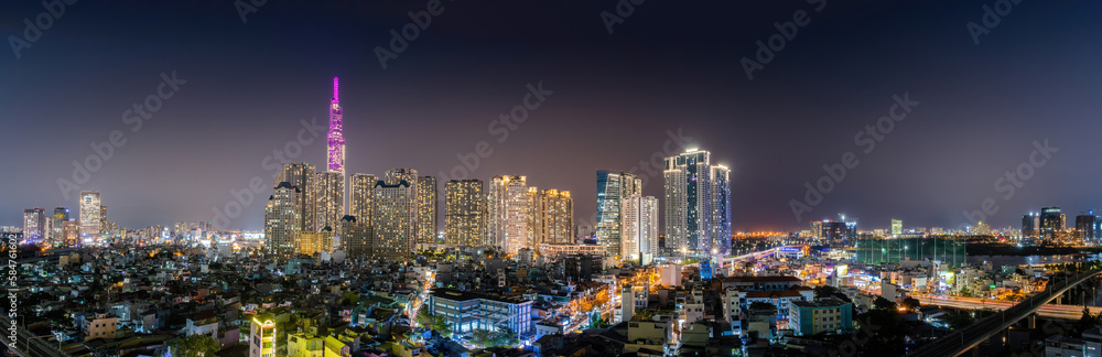 Aerial view of Landmark 81 skyscraper, buildings, roads, houses and Saigon elevated railway line. Travel concept.