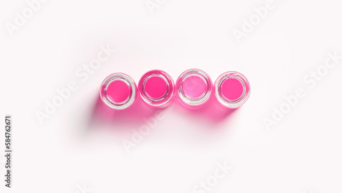 set of flasks, laboratory jars with pink liquid. On a white, light background. View from above.
