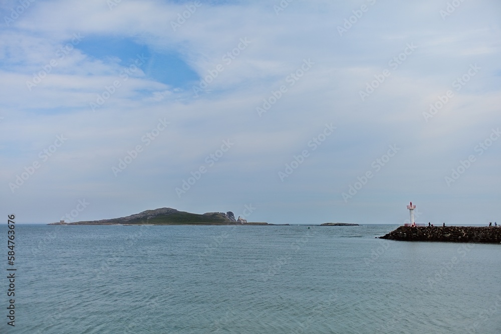 Howth Lighthouse. Harbor and marina in cloudy day in Howth, Dublin, Ireland. 