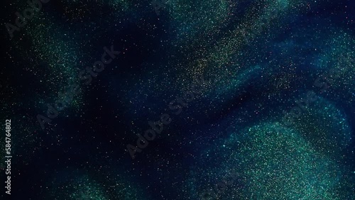 Mesmerizing Slow-Motion 4K Footage of Gold Dust Particles in a Blue Liquid with Green Tint. Golden particles floating and make green tints by dispersion patterns, waves and streams in a blue fluid.