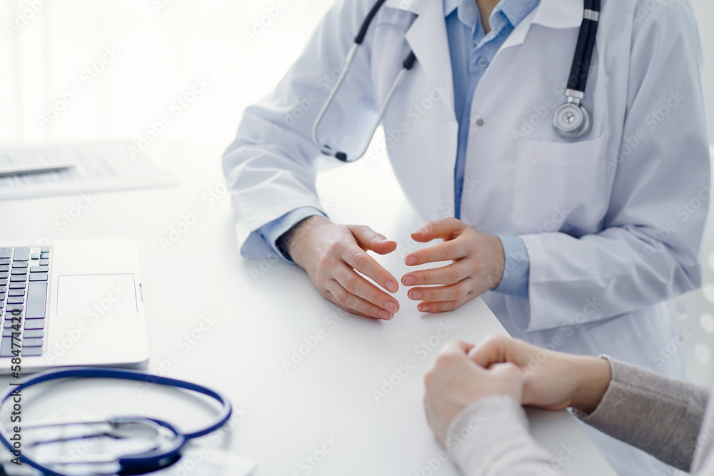 Doctor and patient discussing current health questions while sitting at the table in clinic office, only hands closeup. Medicine concept Doctor and patient discussing current health questions while sitting at the table in clinic office, only hands closeup. Medicine concept