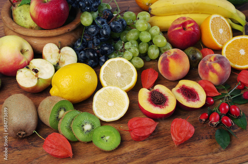 A variety of fruits on a wooden table.