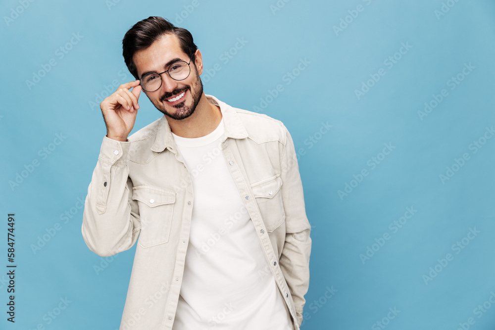 Portrait of a stylish man smile glasses for farsightedness and myopia, on a blue background in a white T-shirt, space space Portrait of a stylish man smile glasses for farsightedness and myopia, on a blue background in a white T-shirt, space space