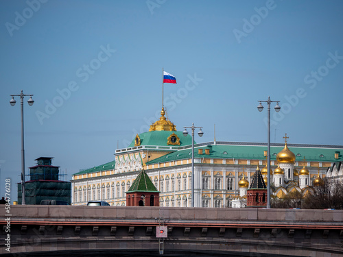 MOSCOW, RUSSIA - MAY 22, 2022: View of the Moscow Kremlin from the Moscow river. Red brick towers and Bell Tower Of Ivan The Great