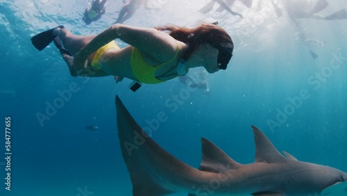 Woman free diving and snorkelling with the nurse shark in a tropical sea in the Maldives photo