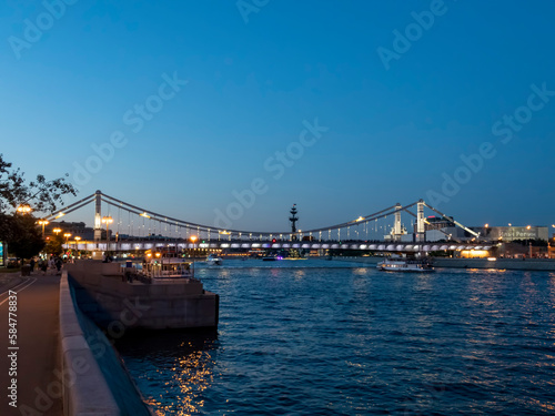 MOSCOW, RUSSIA - MAY 22, 2022: View of the Crimean Krymsky bridge in Moscow from the Gorky park, a popular touristic landmark and place for walking in Moscow photo