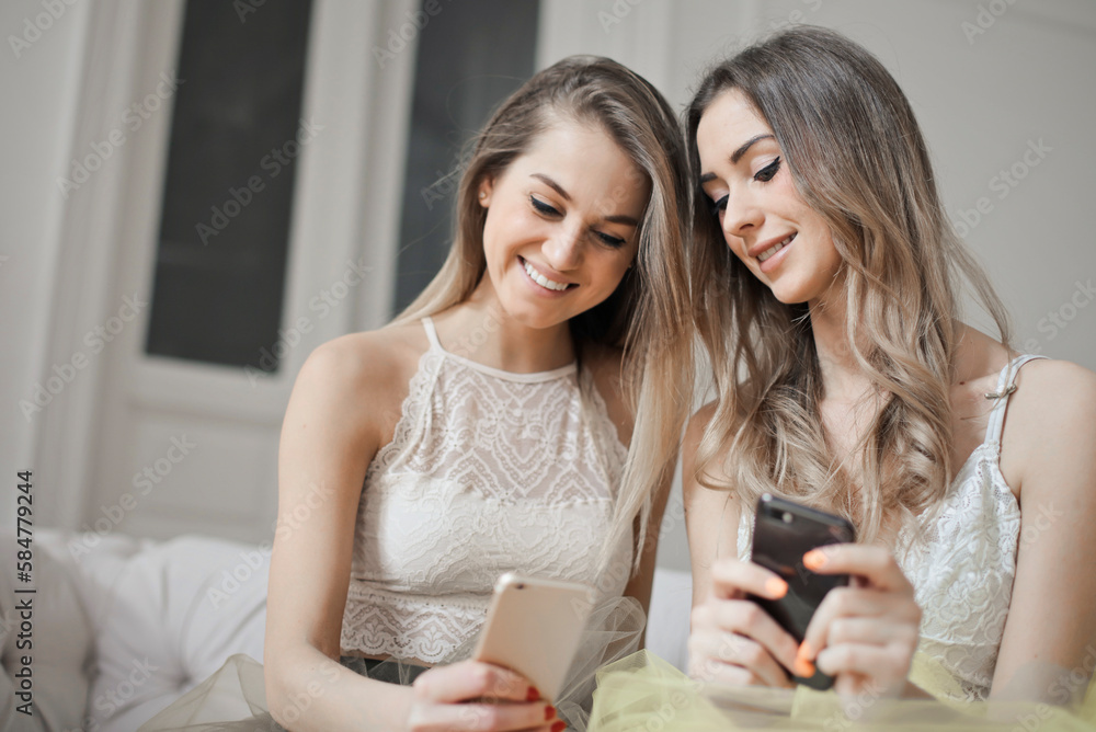 two young women use a smartphone two young women use a smartphone