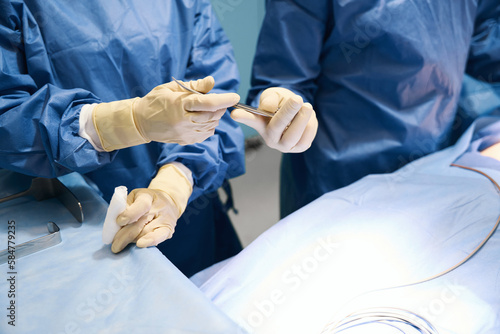 People stand at the surgical table in the operating room
