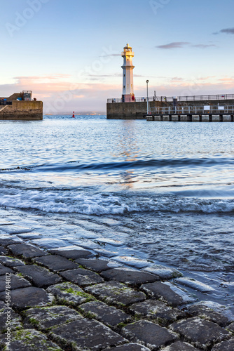 Newhaven Harbour on the Firth of Forth. Newhaven is a district in the City of Edinburgh, Scotland, between Leith and Granton and about 2 miles north of the city centre. Taken just after sunrise. photo