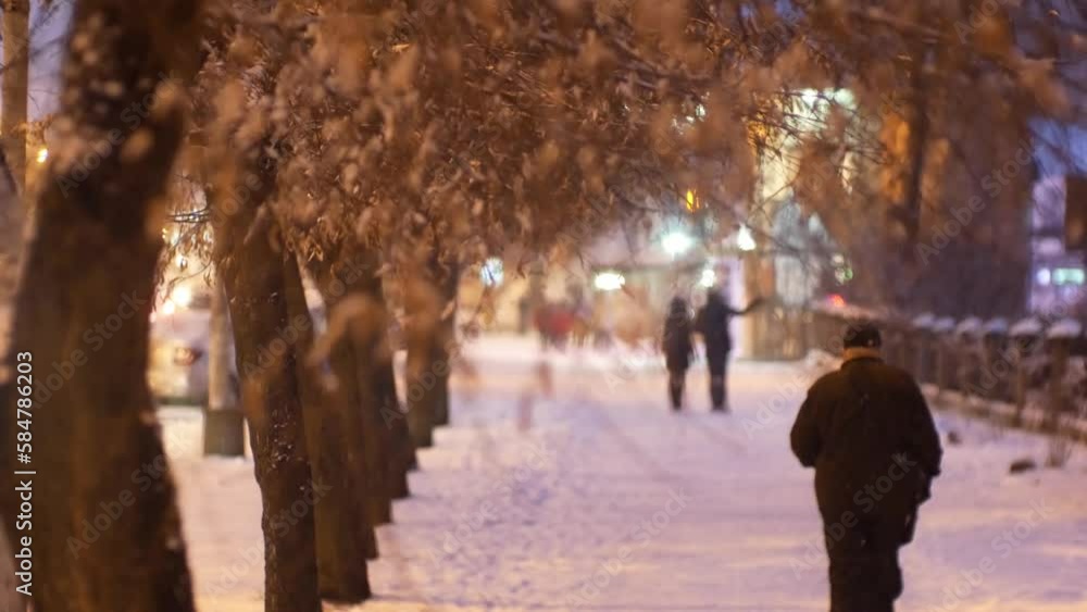 Urban people pedestrians in a snowfall blizzard on a snowy city dark street in cold winter Christmas weather Urban people pedestrians in a snowfall blizzard on a snowy city dark street in cold winter Christmas weather