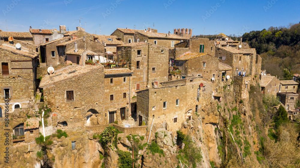 Aerial view of the houses of Calcata, a small town near Viterbo, Italy. All buildings in the historical centre are built in stone and tuff and have red tiled roofs. Italian village.