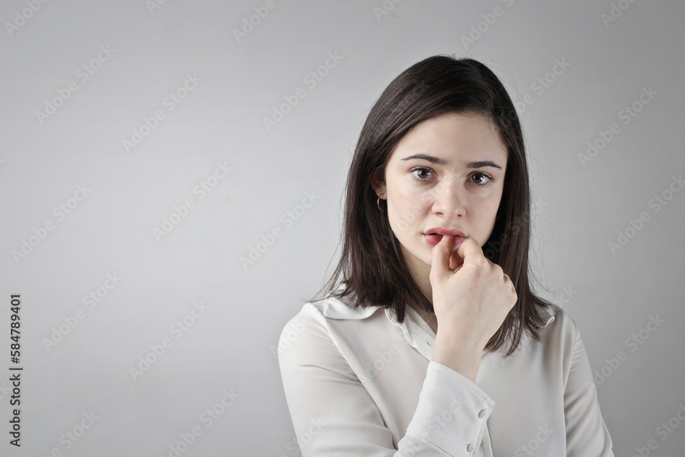 portrait of young girl with indecisive expression portrait of young girl with indecisive expression