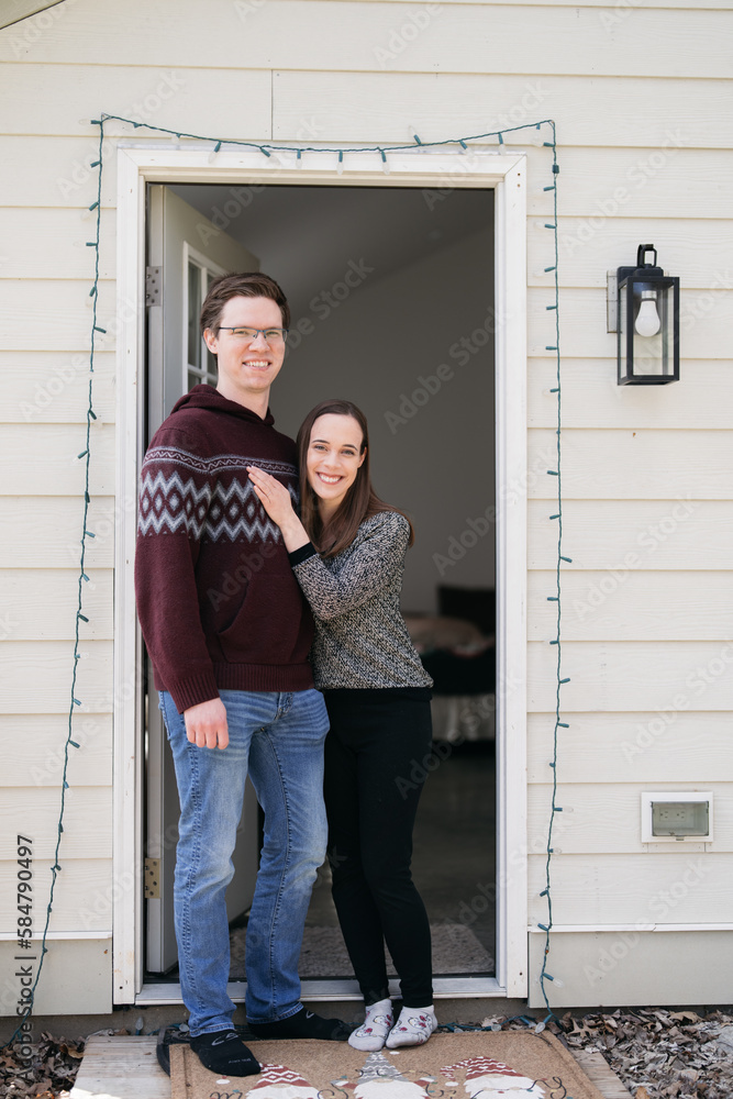 couple in front of house