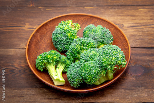 Green fresh broccoli on the table. Old wooden background. broccoli