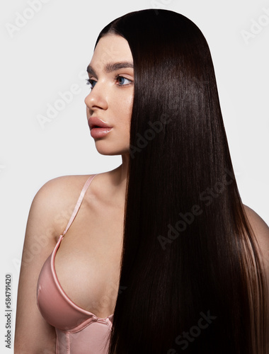 Fashion woman with straight long shiny hair. Beauty and hair care