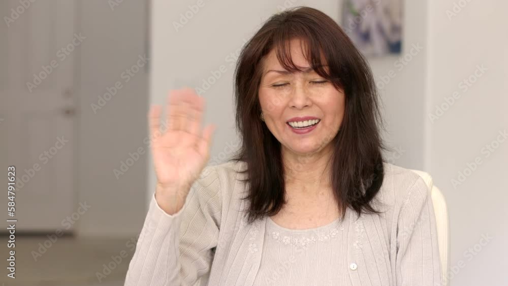 Attractive woman, cheerful face, looking at camera smiling, waving posing sitting at leisure home. Attractive woman, cheerful face, looking at camera smiling, waving posing sitting at leisure home.