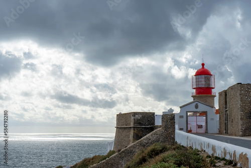 Lighthouse of Cabo de S  o Vicente. View of idyllic nature landscape with rocky cliff shore and waves crashing on.  Sagres  Portugal on February 27  2023