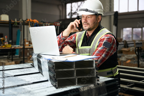 Portrait of worker talking with client on phone