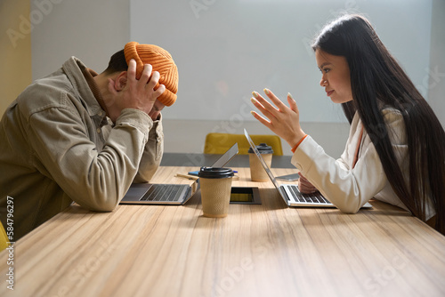 Company manager having difficult conversation with subordinate in meeting room
