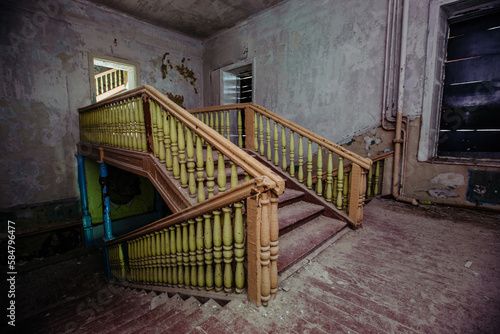 Old wooden staircase in dark abandoned mansion
