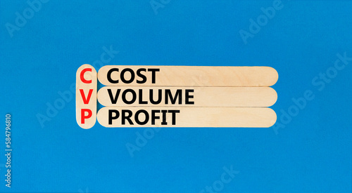 CVP cost volume profit symbol. Concept words CVP cost volume profit on wooden stick on a beautiful blue table blue background. Business and CVP cost volume profit concept. Copy space.