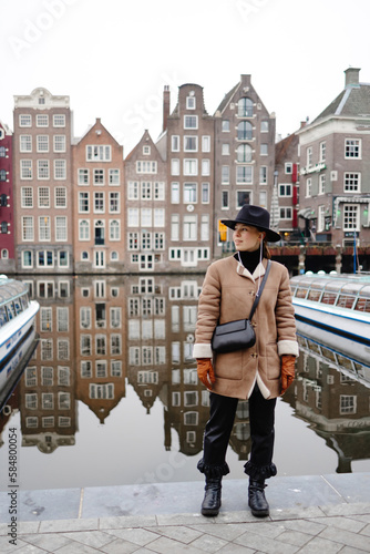 Tourist standing on background of houses in Amsterdam photo
