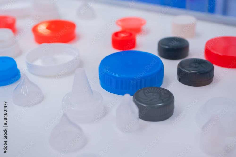 Plastic caps, covers for medical glass bottles in showcase at pharmaceutical exhibition, pharmacy laboratory. Pharma industry, science, medicine, experiment and healthcare concept Plastic caps, covers for medical glass bottles in showcase at pharmaceutical exhibition, pharmacy laboratory. Pharma industry, science, medicine, experiment and healthcare concept