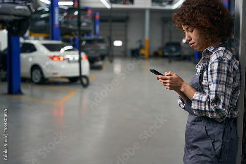 Multiracial employee presses on the buttons of a mobile phone