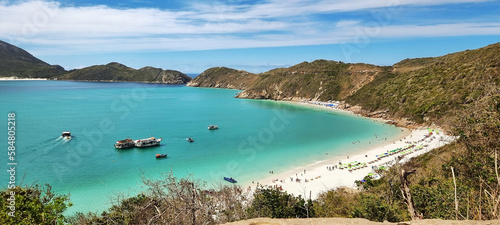 A beautiful beach with crystal clear waters, very sunny on a summer day.