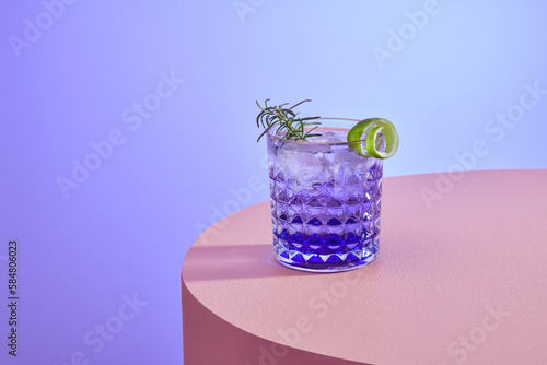 Ice Blue cocktail decorated with lemon and rosemary photo