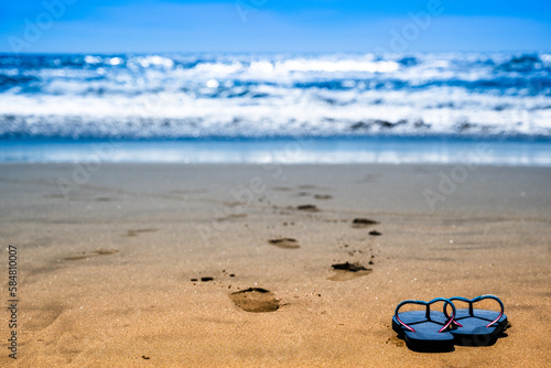 Blue Sandals on Beach with Fine-Grained Sand