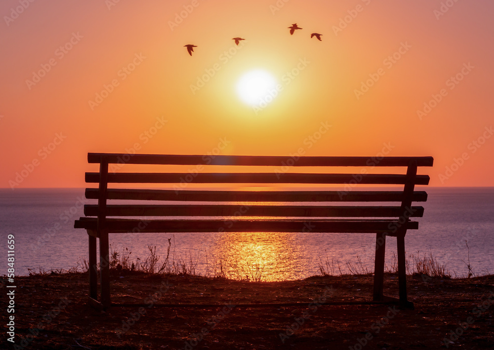 Bench with sea view at sunset