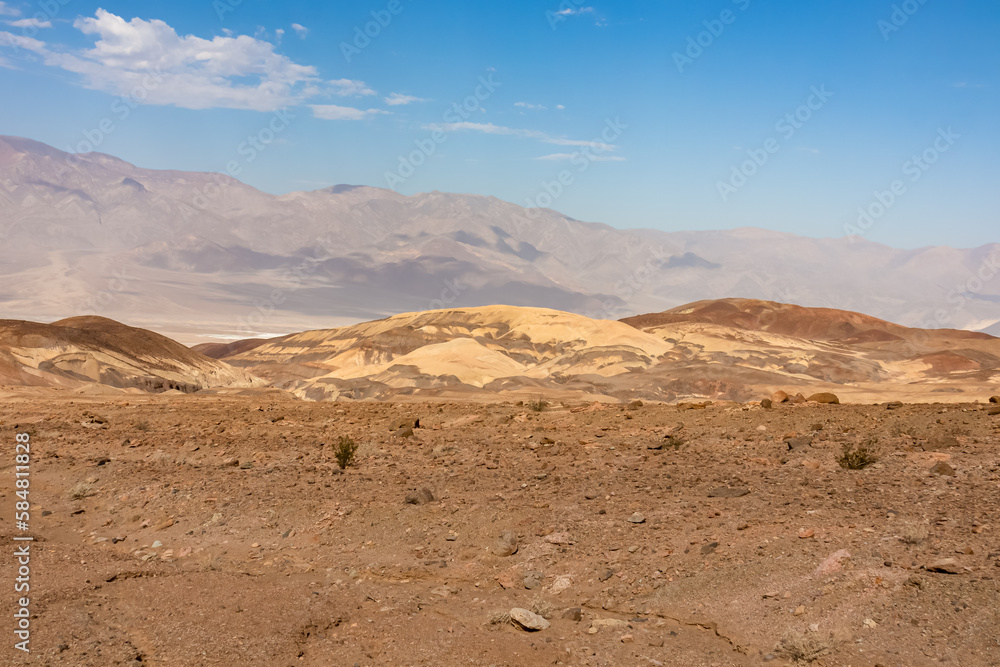 Scenic view of colorful geology of multi hued Artist Palette rock formations in Death Valley National Park, Furnace Creek, California, USA. Black mountains and Amargosa Chaos seen from Artist Drive