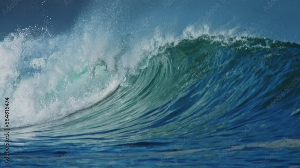 2022 - A clear blue wave curls off the coast of Papohaku Beach, Hawaii. 2022 - A clear blue wave curls off the coast of Papohaku Beach, Hawaii.