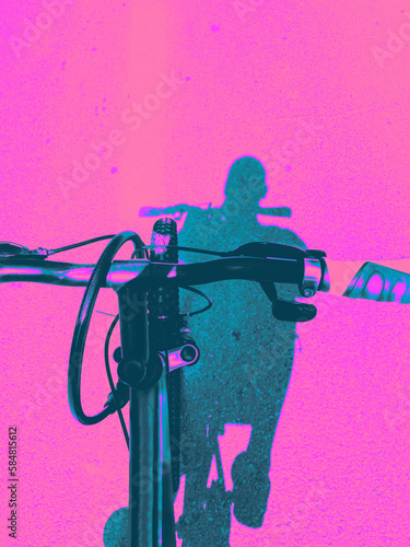 A guy carelessly rides a bicycle in the summertime. photo