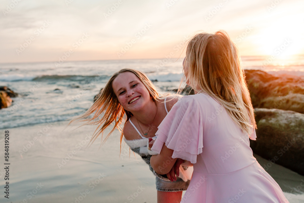 Laughing teenage sisters outdoors together Laughing teenage sisters outdoors together