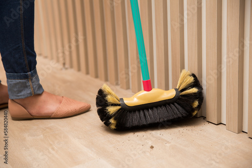 Woman sweeping the floor at home - BROOM