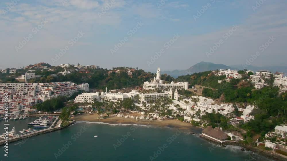 Manzanillo, Mexico - 11.21.2022 Aerial view of Peninsula de Santiago in city Manzanillo, Mexico. Beautiful bitch and luxury hotels and boat and yacht berth Manzanillo, Mexico - 11.21.2022 Aerial view of Peninsula de Santiago in city Manzanillo, Mexico. Beautiful bitch and luxury hotels and boat and yacht berth