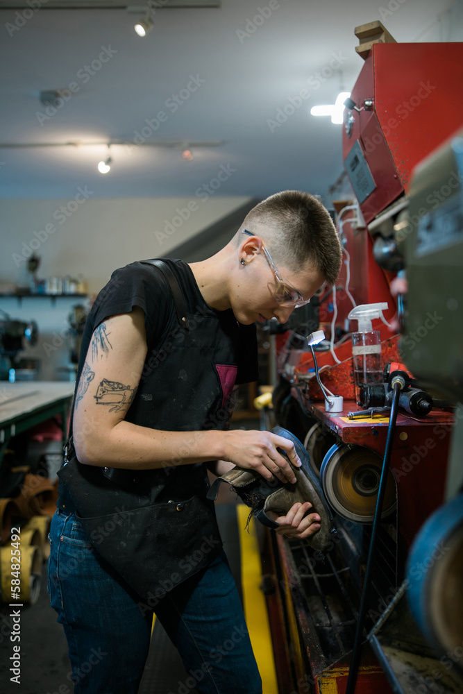 Worker fixing boot sole.