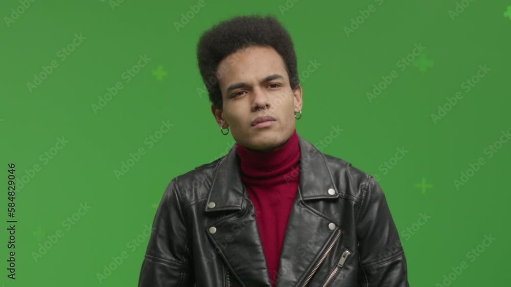 CHROMA KEY Portrait of 20s African-American male student pretending he is visiting art exhibition against green screen CHROMA KEY Portrait of 20s African-American male student pretending he is visiting art exhibition against green screen