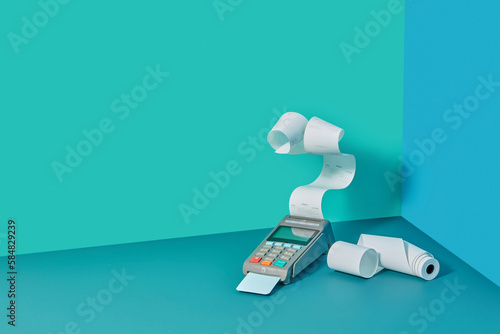 POS terminal with pay receipt and paper rolls.