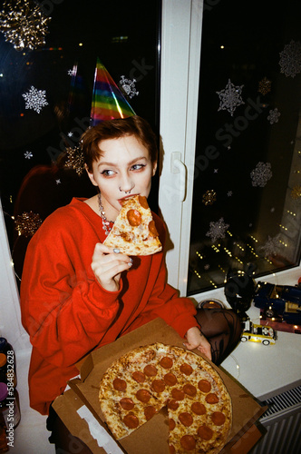 girl eating pizza at a party photo