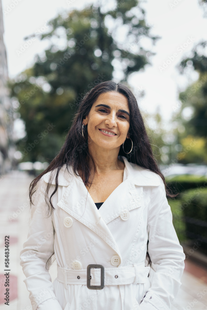 Portrait of a smiling middle-aged woman in the city Portrait of a smiling middle-aged woman in the city