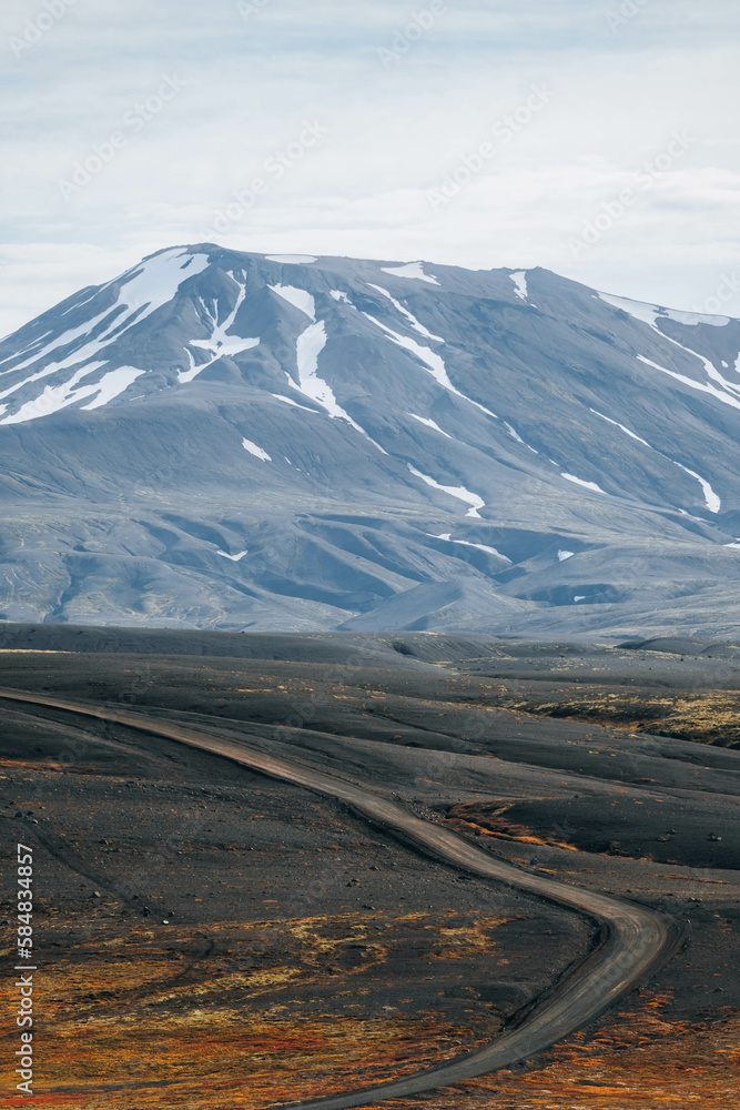 Empty Gravel Road on Mountains and cloudy sky on background Empty Gravel Road on Mountains and cloudy sky on background