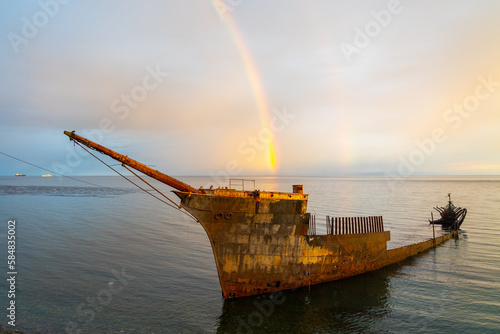 Lord Lonsdale shipwreck with rainbow at dusk in the coast of Punta Arenas, Chile. The Lord Lonsdale started its final journey in Hamburg, Germany in 1909, why it ended up here is a mystery. photo