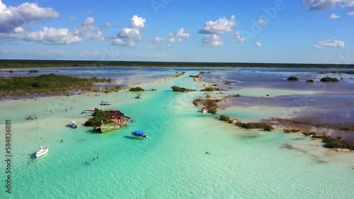 Bacalar,Quintana Roo, Mexico-Nov.27th 2017: drone view descent over the canal de los piratas of Bacalar Lagoon of 7 colors with blue turquoise waters, blue sky and white clouds